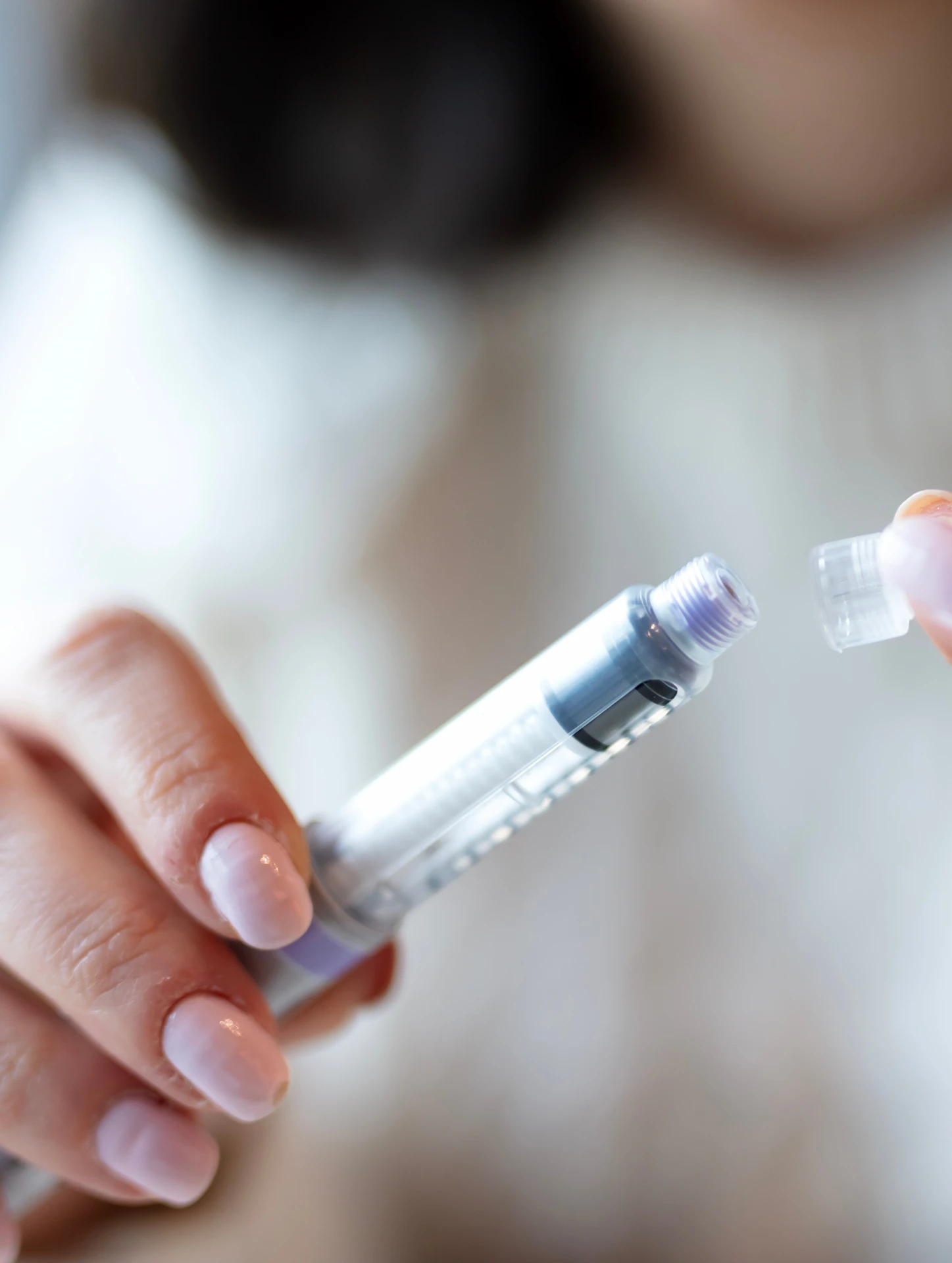 close up of someone holding an injection