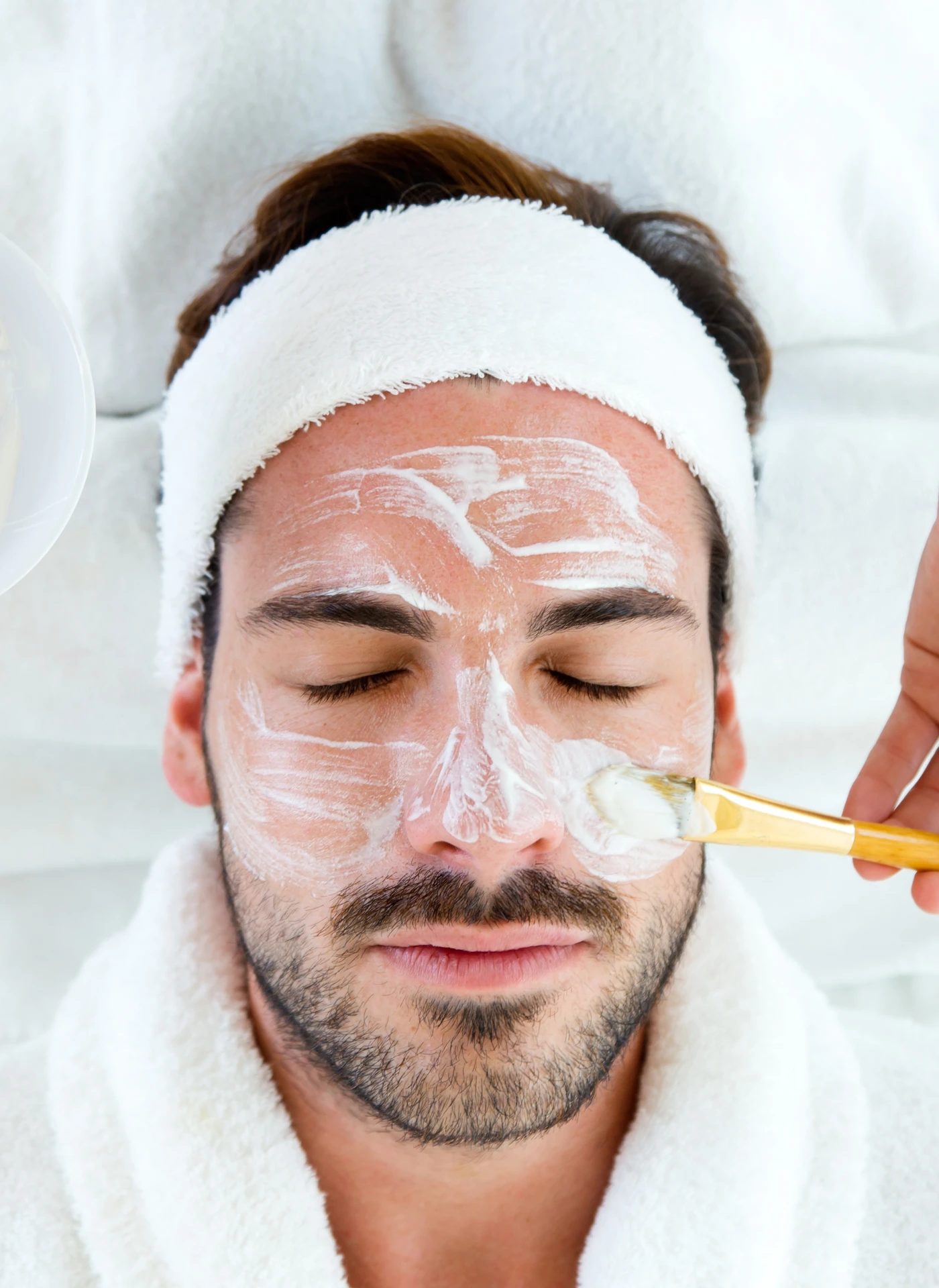 cream being applied to a mans face