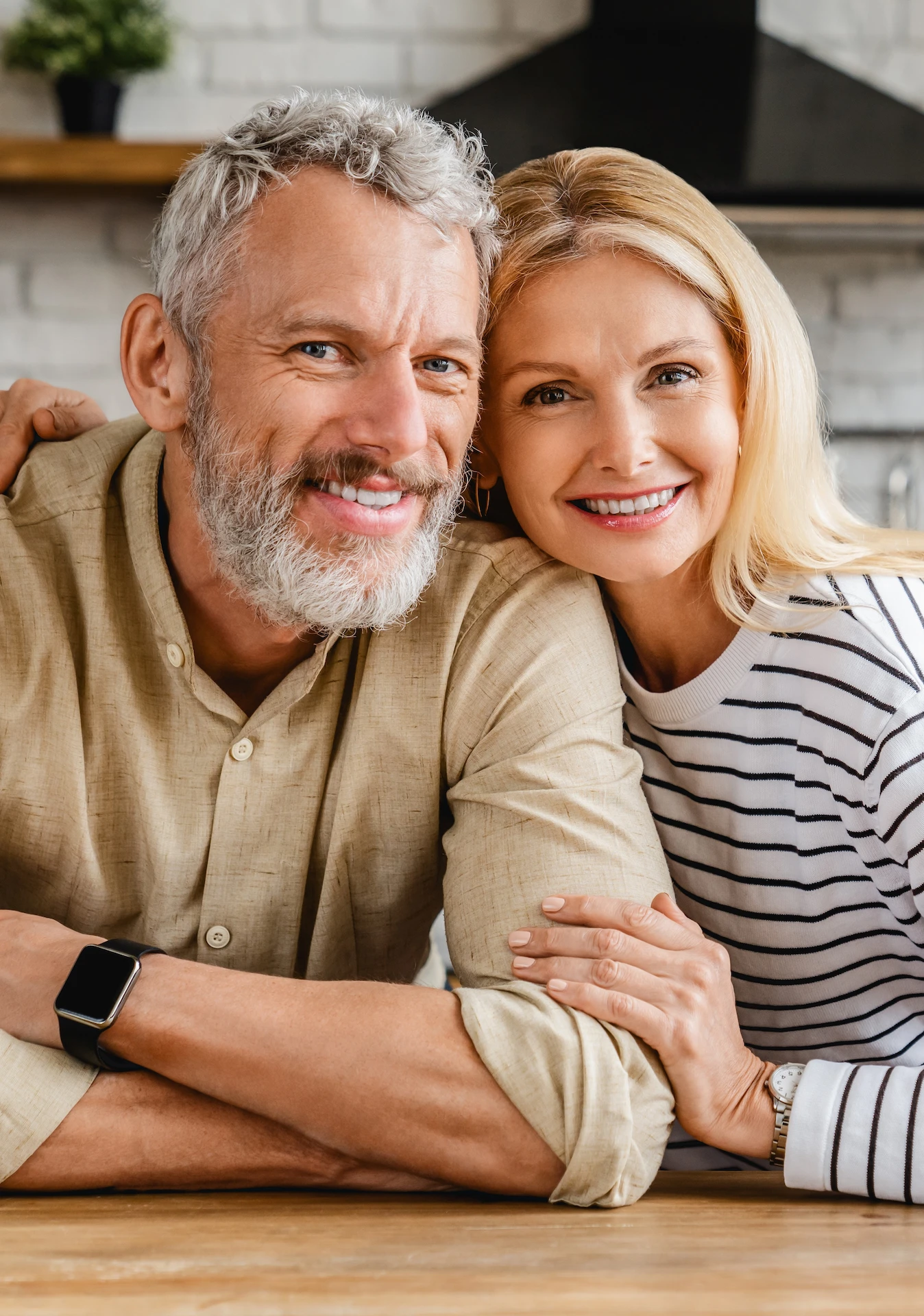 man and woman sitting together in a kitchen
