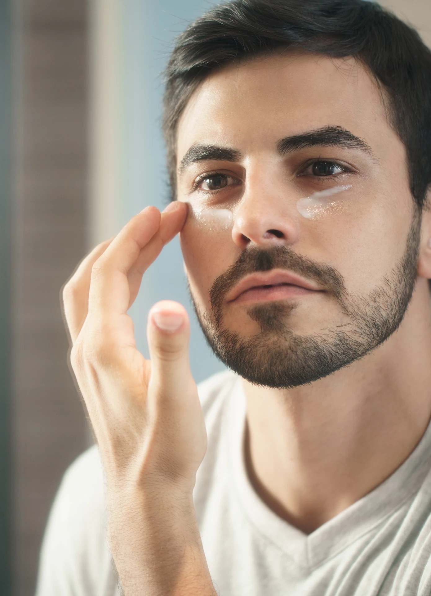 man applying cream to his face