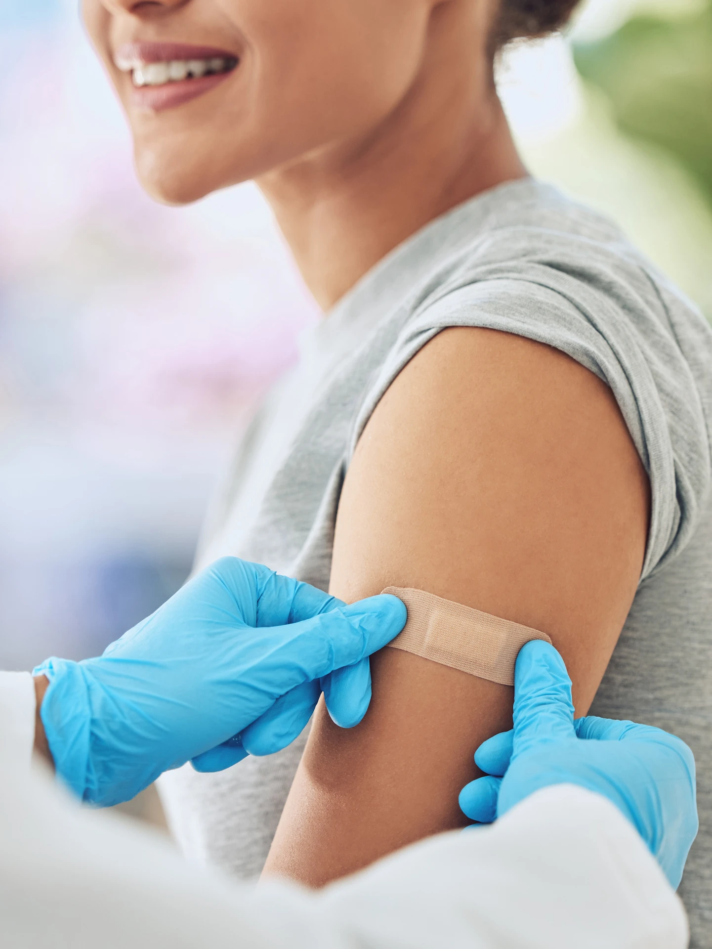 woman having a plaster put on her arm